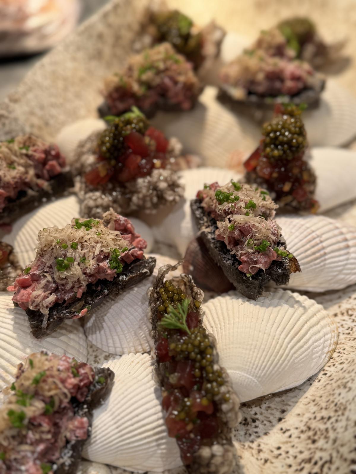 Beef tartare canapés with caviar on scallop shells
