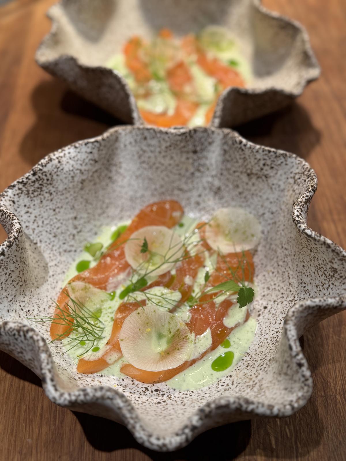 Salmon crudo with cucumber and dill in a wave-edge bowl
