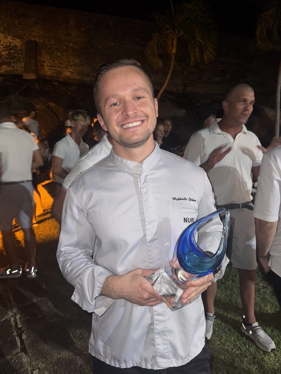 Chef Mykhailo holding competition trophy